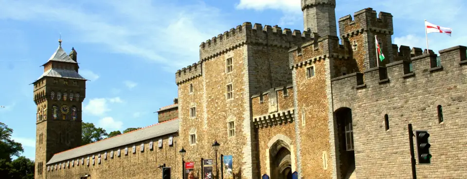 The clock tower and walls of Cardiff Castle under a blue sky