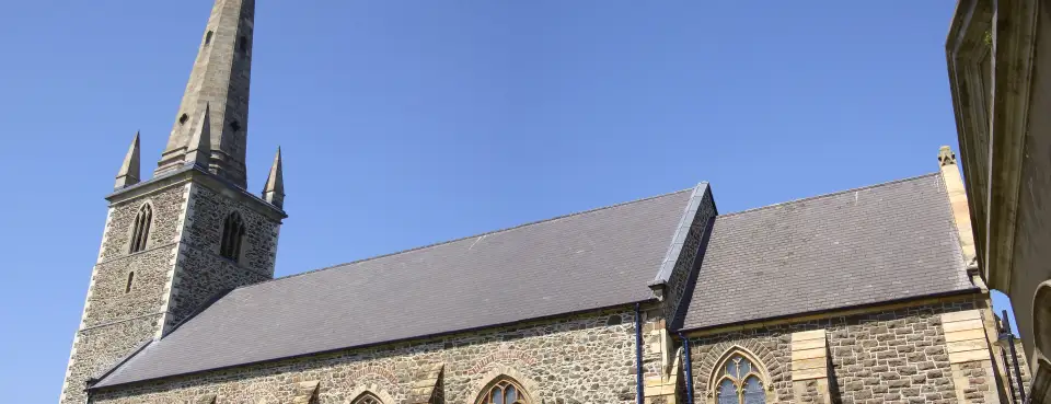 Lisburn Cathedral and its spire under a blue sky