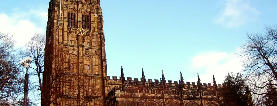 The tower of St Giles' Church, Wrexham, under a blue sky